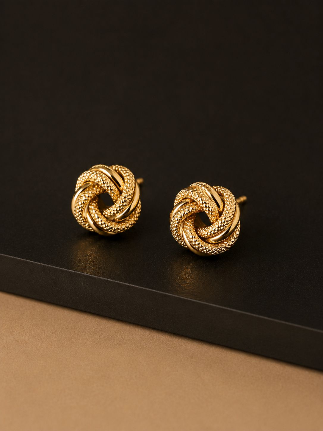 Solid gold braided love knot stud earrings