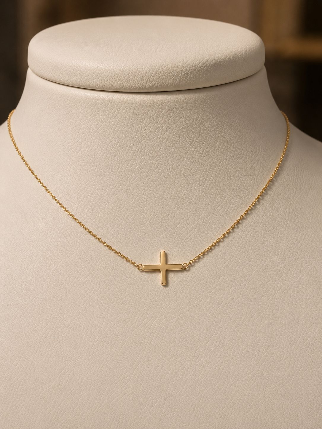 Gold sideways cross necklace on a fine chain