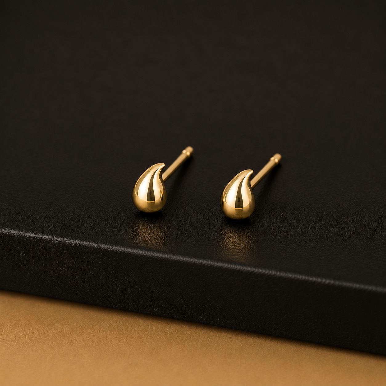 Polished solid gold teardrop stud earrings