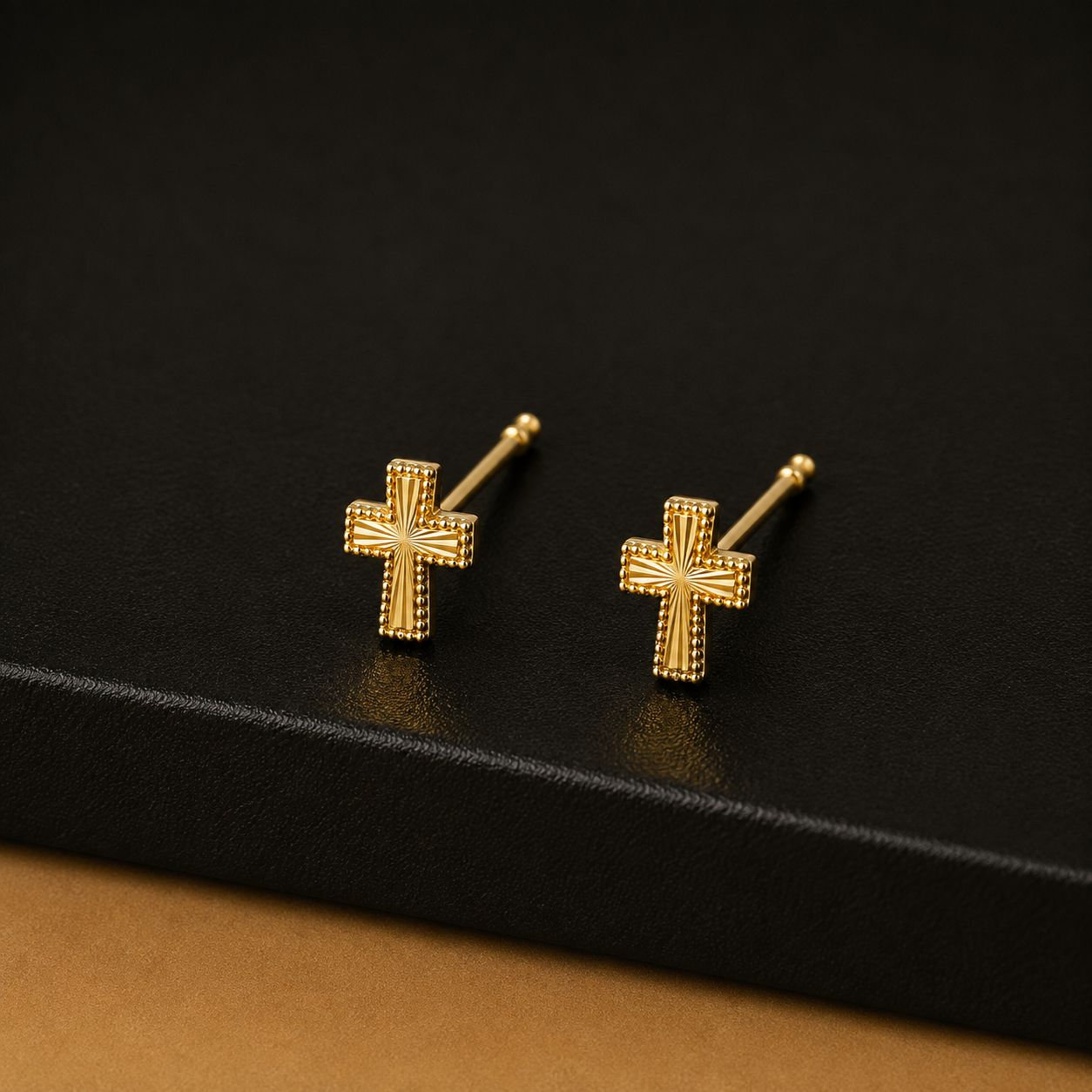 Solid gold cross stud earrings with sunburst engraving