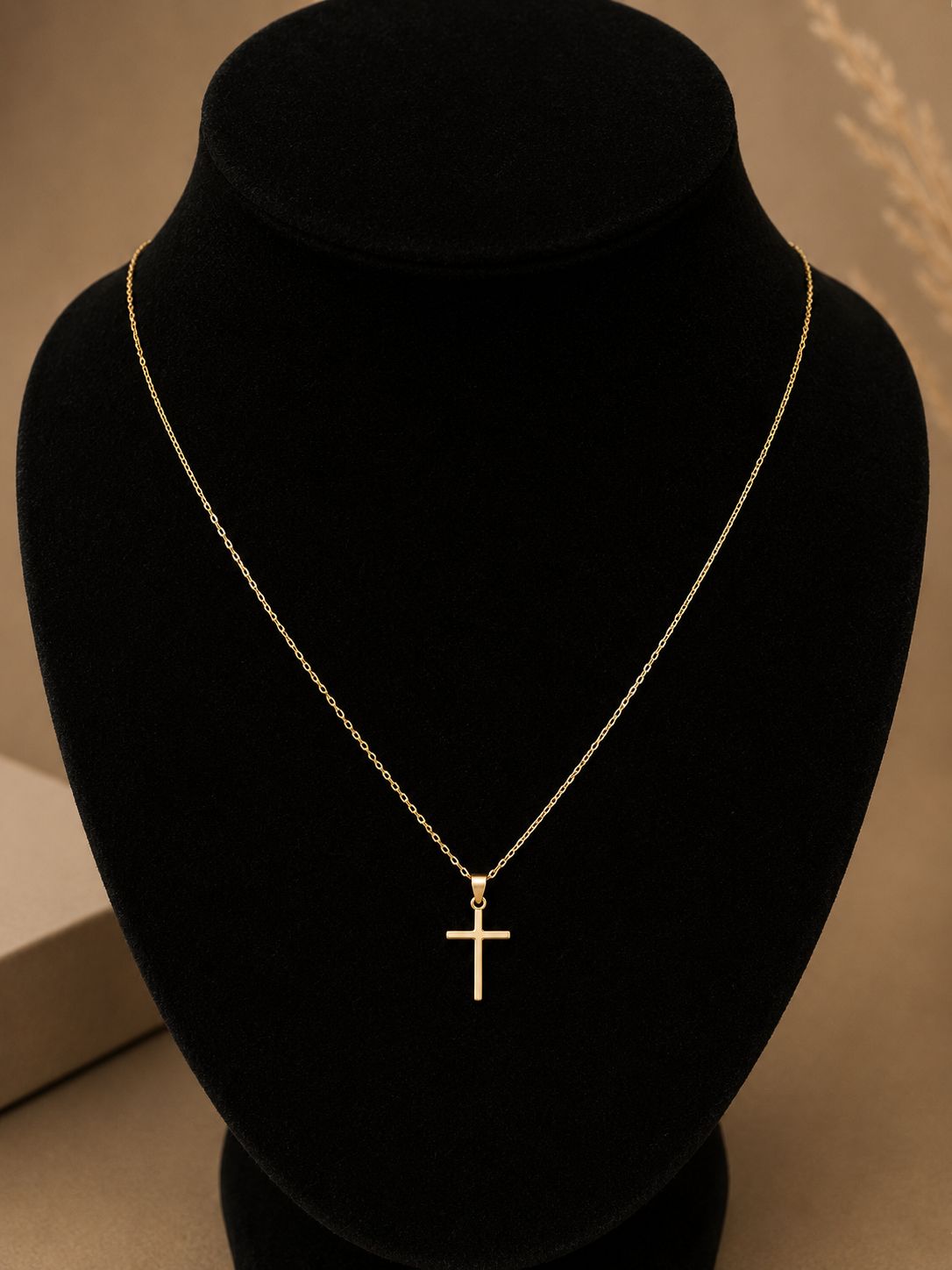 Slim polished gold cross pendant on a fine chain