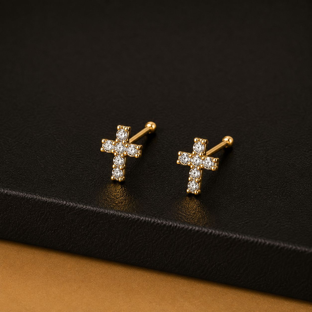 Gold cross stud earrings set with clear stones